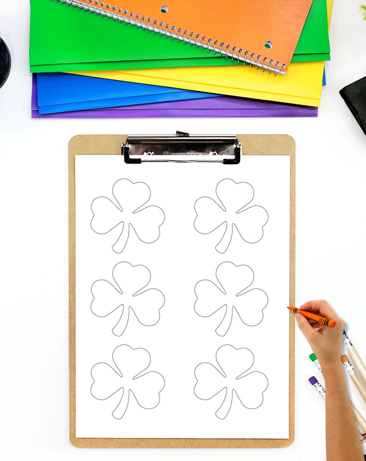 a page with three shamrocks on a clipboard