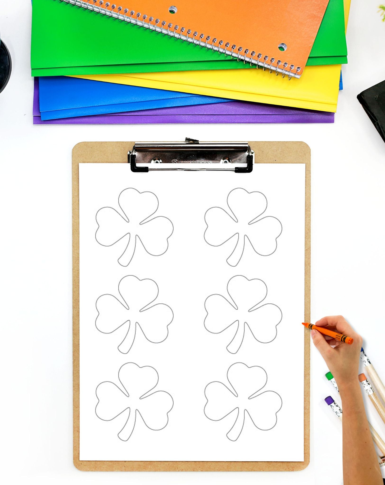a page with three shamrocks on a clipboard
