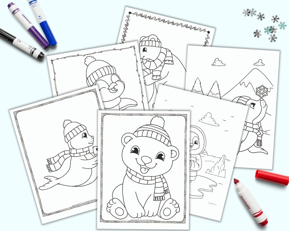 A flatlay mockup with 6 printable cute winter animal  coloring pages on a blue background with colorful children's markers. The pages feature polar bears, penguins, and seals.